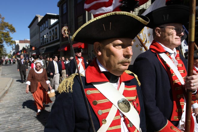 Newport's Columbus Day parade marches toward the Columbus monument on Memorial Boulevard, in 2015, with the Artillery Company of Newport, 1741, in front. The Providence Journal files/Bob Breidenbach