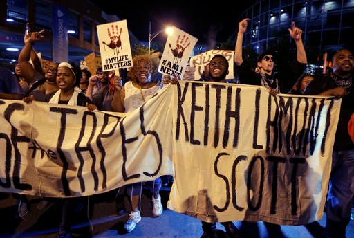 Protesters shout as they march in the streets of Charlotte, North Carolina, Friday to protest Tuesday's fatal police shooting of Keith Lamont Scott.