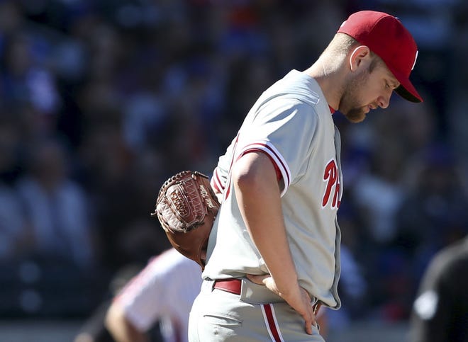 Phillies starting pitcher Jake Thompson reacts after hitting New York Mets' Rene Rivera with a pitch during the fifth inning at Citi Field, Sunday, Sept. 25, 2016 in New York. The Phillies lost 17-0.