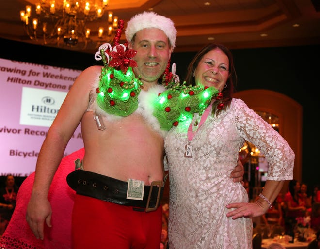 Breast cancer survivor Sally Sebastyn celebrates with Owen Chittenden with The Shores Resort and Spa during the 2015 BraTini event. News-Journal/NIGEL COOK