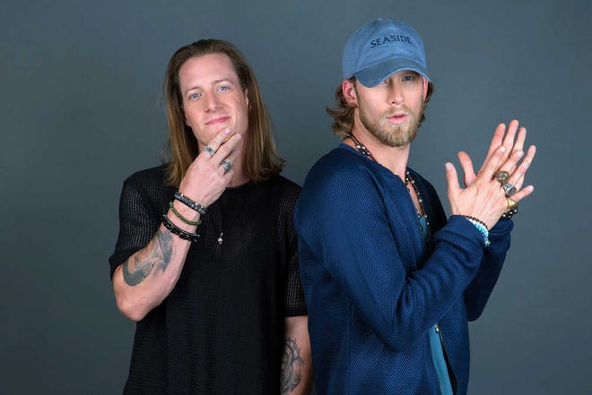 In this Aug. 25, 2016 photo, Tyler Hubbard, left, and Brian Kelley of Florida Georgia Line pose for a portrait in New York to promote their latest album, "Dig Your Roots. (Photo by Amy Sussman/Invision/AP)