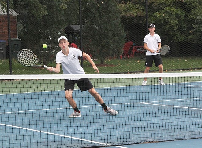 Ethan Pattison returns a shot in front of brother Jesse Pattison Saturday in one of their matches at third doubles.