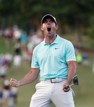 Rory McIlroy reacts after sinking a putt on the fourth hole to win the Tour Championship golf tournament and the FedEx Cup at East Lake Golf Club, Sunday, Sept. 25, 2016, in Atlanta.