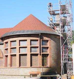 Scaffolding surrounds the chimney of the Ilion Free Public Library, at 78 West St., as part of the masonry restoration project currently going on at the building. TIMES TELEGRAM PHOTO/STEPHANIE SORRELL-WHITE
