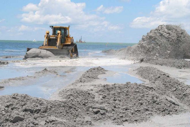 Provided by U.S. Army Corps of Engineers Jacksonville Division Bulldozers push dredged sand along the beaches to rebuild the shoreline to its original design. The U.S. Army Corps of Engineers Jacksonville Division adds sand to the beaches every five to six years to combat beach erosion.