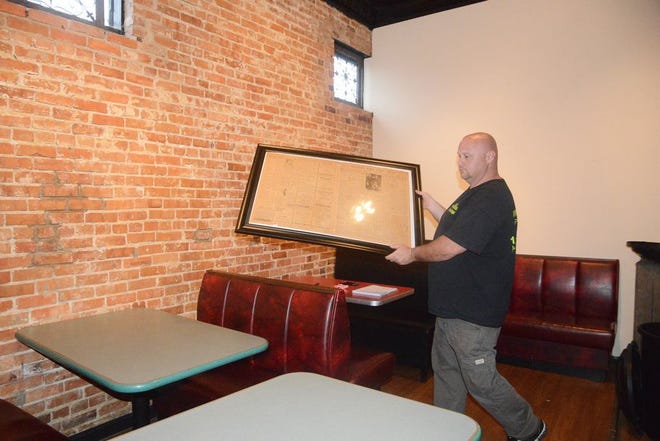Nicky Rapoza, the owner of North Street Pub, works inside the pub as the restaurant prepares for its opening.