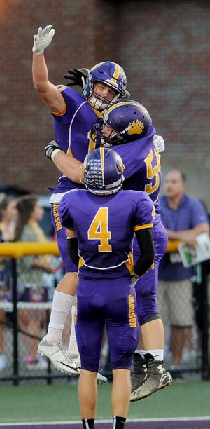 Dillon Dingler and his Jackson teammates, celebrating at touchdown in a Wee 5 win over Lake, are ranked fourth in the state in Division I. (CantonRep.com / Ray Stewart)