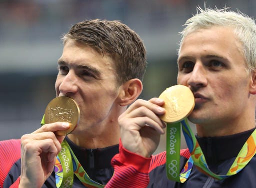 FILE - In this Wednesday, Aug. 10, 2016, file photo, United States' Michael Phelps, left, and Ryan Lochte celebrate winning the gold medal in the men's 4x200-meter freestyle relay during the swimming competitions at the 2016 Summer Olympics in Rio de Janeiro, Brazil. Phelps isn't sure what kind of moves Lochte has planned for "Dancing with the Stars." "I've never seen him dance," the 23-time Olympic gold medalist said Friday, Sept. 2, at the "Call of Duty" fan convention in Inglewood, Calif. (AP Photo/Lee Jin-man, File)