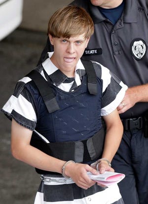 FILE - In this Thursday, June 18, 2015, file photo, Charleston, S.C., shooting suspect Dylann Roof is escorted from the Cleveland County Courthouse in Shelby, N.C. The first jurors report to the federal courthouse in Charleston, S.C., on Monday, Sept. 26, 2016 for jury screening in the federal death penalty case charging Roof with hate crimes and other charges. He is charged in the June, 17, 2015 slayings of nine people during a Bible study at Emanuel AME Church in Charleston. (AP Photo/Chuck Burton, File)
