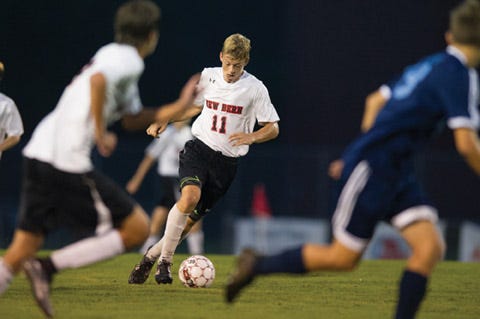 New Bern’s Daniel Rust (11) dribbles the ball downfield during a soccer game against C.B. Aycock at New Bern High School Tuesday.