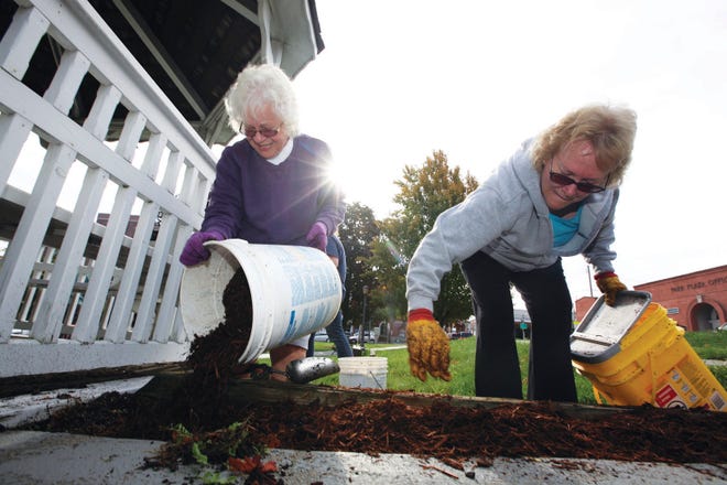 Photo by Daniel Freel/New Jersey Herald - Maureen Blandino, left, and Barbara Anderson, both of Vernon, spread mulch around the gazebo on the Newton Green.