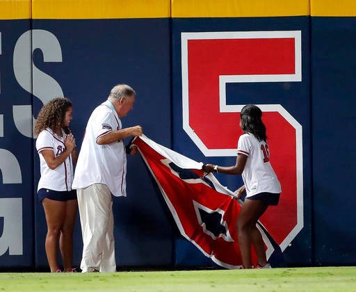 Former Atlanta Braves manger Bobby Cox pulls the number 6 off the left field wall to reveal there are only five games left to be played at Turner Field during after the fifth inning of a baseball game against the Philadelphia Phillies Tuesday, Sept. 27, 2016, in Atlanta. (AP Photo/John Bazemore)