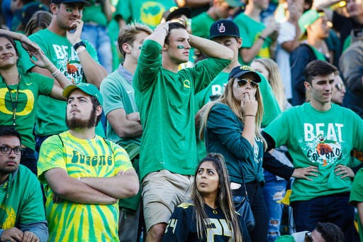 FILE - In this Sept. 24, 2016 file photo, Oregon fans react to the last second interception that sealed their loss against Colorado in an NCAA college football game in Eugene, Ore. Veteran Oregon players addressed their teammates on a practice field on Monday, Sept. 26, 2016, two days after the Ducks’ 41-38 loss at home to Colorado. (AP Photo/Thomas Boyd, File)