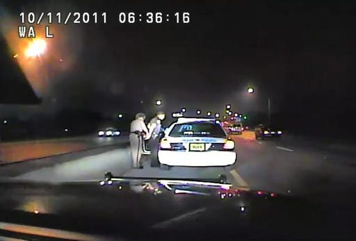In this image made from an Oct. 11, 2011 video made available by the Florida Department of Highway Safety and Motor Vehicles, Florida Highway Patrol Officer Donna Watts arrests Miami Police Department Officer Fausto Lopez who was traveling at 120 miles per hour to an off-duty job, in Hollywood, Fla. After the incident, Watts says that she was harassed with prank calls, threatening posts on law enforcement message boards and unfamiliar cars that idled near her home. In lawsuits, she accused dozens of officers of obtaining information about her in the state’s driver database. (Florida Department of Highway Safety and Motor Vehicles via AP)