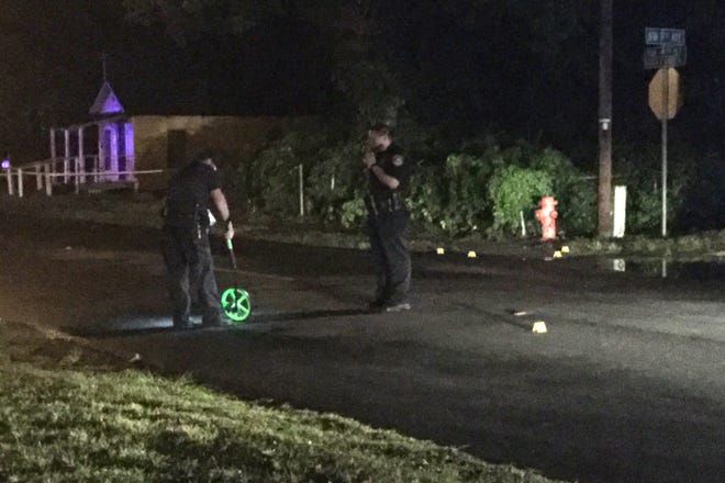 Police officials work at the scene of a drive-by shooting in northwest Ocala Wednesday night. (Austin L. Miller/Star-Banner)
