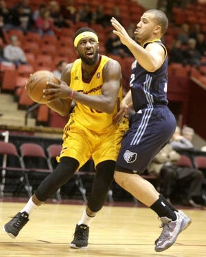 Former Charge guard John Holland looks to shoot during a game against Iowa's Traevon Jackson last season. Holland is in Cavaliers training camp competing for a roster spot. (CantonRep.com file photo)