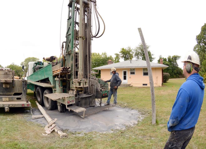 Chris Gerrish, of Wauregan, right, and Howard Barber, of Dayville, employees at LaFramboise Well Drilling in Thompson, drill 300 feet down and find water Wednesday on Rooselvelt Avenue in Norwich. See videos at NorwichBulletin.com John Shishmanian/ NorwichBulletin.com