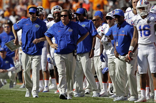 Florida head coach Jim McElwain, second from left, looks on during the first half of the game Saturday against Tennessee. The Associated Press