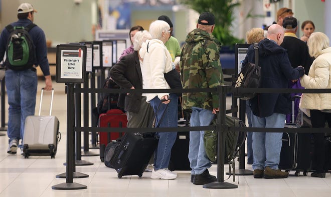 Travelers wait to go through security at Northwest Florida Beaches International Airport. Passenger traffic was down in August 2016, the sixth consecutive months of declines. ANDREW WARDLOW/News Herald file photo