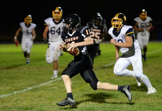 Maynard High sophomore quarterback Tommy Smith runs for a touchdown, putting his team up 18-6 in the 4th quarter of the game against Littleton High, Sept. 23, 2016. The Maynard Tigers beat the Tigers of Littleton, 20-6. (Wicked Local Staff Photo/John Walker)