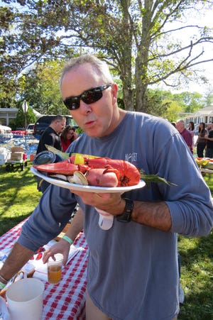 Jim Botsford gets ready for a lobster meal as part of the food and music festival called ClamBQ in Orleans. CASEY GALLANT