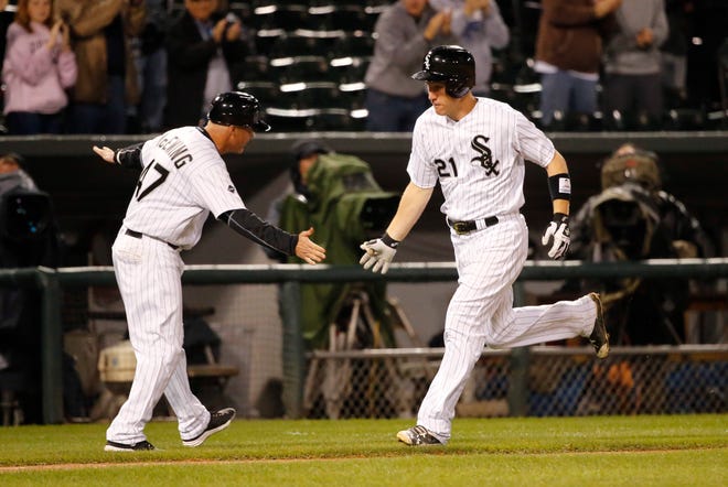Chicago White Sox's Todd Frazier (21) rounds third and celebrates his home run off Tampa Bay Rays relief pitcher Eddie Gamboa with third base coach Joe McEwing during the seventh inning of a baseball game Wednesday, Sept. 28, 2016, in Chicago. (AP Photo/Charles Rex Arbogast)