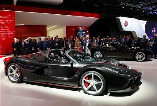 The new Ferrari Aperta is unveiled during the first press day at the Paris Auto Show in Paris, France, Thursday, Sept. 29, 2016. The Paris Auto Show will open its gates to the public from Oct. 1st to 16th. (AP Photo/Christophe Ena)