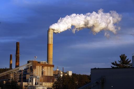 FILE - In this Jan. 20, 2015 file photo, a plume of steam billows from the coal-fired Merrimack Station in Bow, N.H. If the nation doesn’t do more, the U.S. probably won’t quite meet the dramatic heat-trapping gas reduction goal it promised in last year’s Paris agreement to battle climate change, according to a new study. (AP Photo/Jim Cole, File)