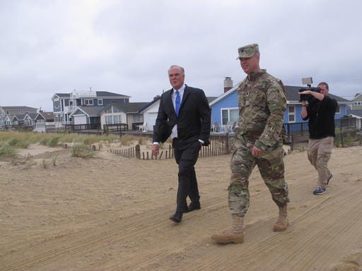 New Jersey Environmental Protection Commissioner Bob Martin, left, and Lt. Col. Michael Bliss of the U.S. Army Corps of Engineers inspect a beach in Toms River, N.J. on Thursday Sept. 29, 2016. A massive project to build protective sand dunes in the section of the Jersey shore hardest hit by Superstorm Sandy four years ago will begin soon. (AP Photo/Wayne Parry)