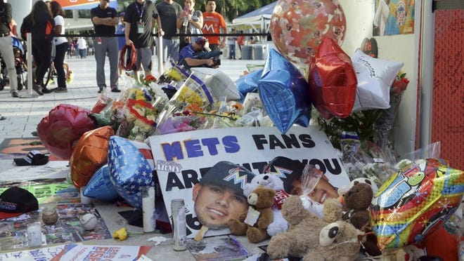 Items sit at a makeshift memorial in memory of Miami Marlins pitcher Jose Fernandez outside of Marlins Park, before a baseball game between the Miami Marlins and the New York Mets, Tuesday, Sept. 27, 2016, in Miami. Fernandez was killed in a boating accident Sunday. (AP Photo/Lynne Sladky)
