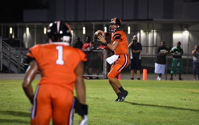 Sarasota High's Bryan Gagg prepares to throw a pass to Dyshone Hayes during the Sailors game against Palmetto High earlier this season at Cleland Stadium at Sarasota High. Herald-Tribune Archive