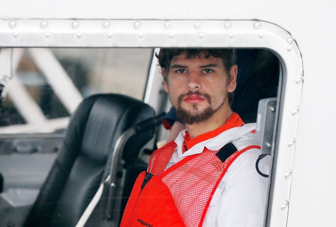 Nathan Carman arrives in a small boat at the US Coast Guard station in Boston, Tuesday, Sept. 27, 2016. Carman spent a week at sea in a life raft before being rescued by a passing freighter. (AP Photo/Michael Dwyer)