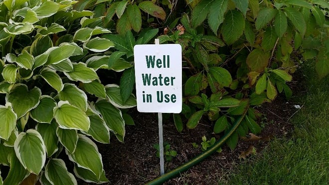Well Water in Use sign at Concord's Trinitarian Congregational Church. A church official said the chruch stopped using its private well earlier this month to water its lawn. Wicked Local photo/Henry Schwan.