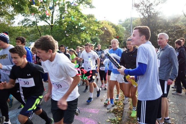 Owen Searle fires off a confetti cannon at the start of the 2015 fun run.
