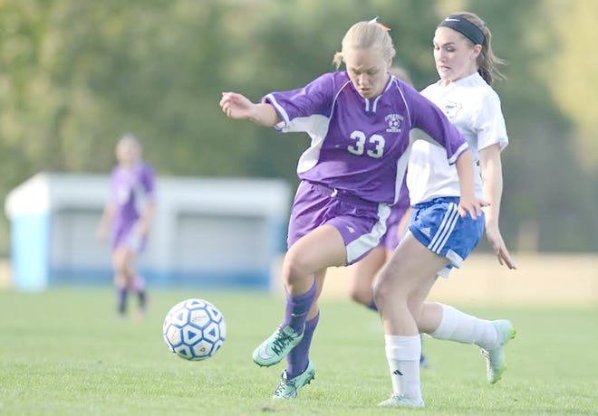 Little Falls Mountie Kailee Jasewicz (left) brings the ball down the field as Mt. Markham player Kelsie Atwell defends during Tuesday’s match.  

Observer-Dispatch Photo/Tina Russell