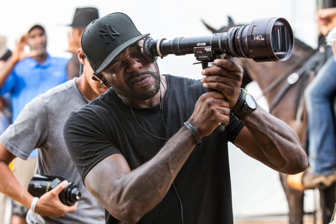 In this image released by Sony Pictures, director Antoine Fuqua appears on the set of "The Magnificent Seven." (Sam Emerson/Sony Pictures via AP)