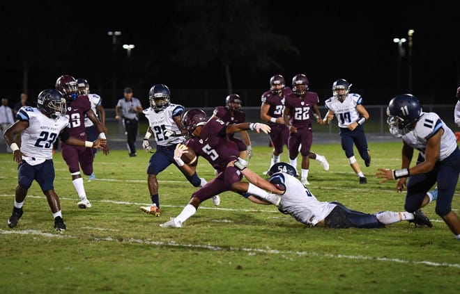 North Port High's Andrew Koennemann tries to stop Braden River High's Tyrone Collins during Friday night's game at Braden River High. HERALD-TRIBUNE STAFF PHOTO / RACHEL S. O'HARA