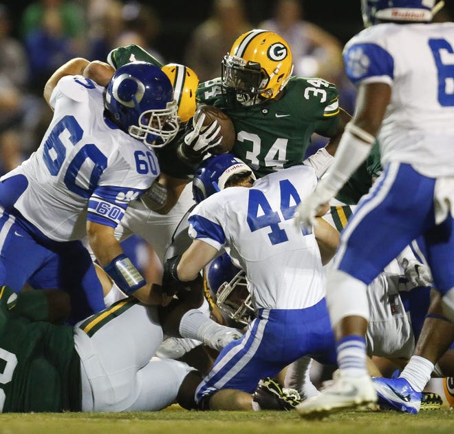 Gordo´s Aarion Steele is wrapped up by Oakman´s Jacob Ingram and Isaac Robinson during Friday night's game at Gordo. Staff Photo/Gary Cosby Jr.