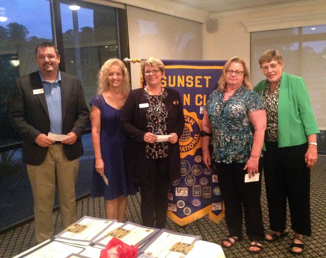 Civitan Club President Mary Kay Pyles, right, awarded $750 checks to representatives of four local agencies, from left, Brian Walton of The Arc of Volusia, Inc.; Ginny Kent of Halifax Urban Ministries; and Carol Collins of Stewart Marchman ACT.