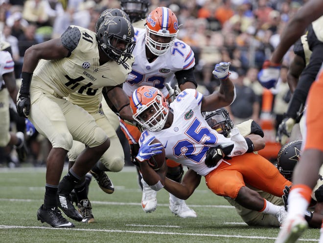 Florida running back Jordan Scarlett (25) is brought down as he carries the ball against Vanderbilt in the second half Saturday in Nashville, Tennessee. ASSOCIATED PRESS/MARK HUMPHREY