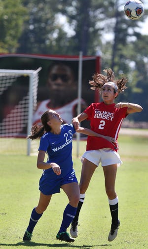 Southern Wesleyan Amber Goss (23) fights for the header with Abbey Kate Hennessy (2) as Belmont Abbey hosted Southern Wesleyan in women's soccer Saturday afternoon. MIKE HENSDILL/THE GAZETTE