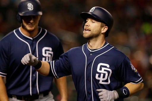 San Diego Padres Ryan Schimpf, right, celebrates after hitting a two-run home run against the Arizona Diamondbacks in the fourth inning during a baseball game, Friday, Sept. 30, 2016, in Phoenix. (AP Photo/Rick Scuteri)
