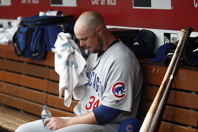 Chicago Cubs starting pitcher Jon Lester sits in the dugout after closing the third inning of a baseball game against the Cincinnati Reds, Saturday, Oct. 1, 2016, in Cincinnati. (AP Photo/John Minchillo)