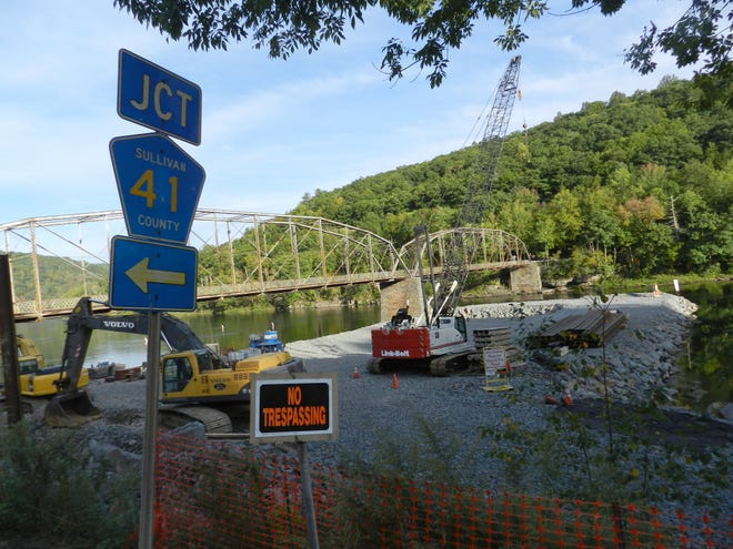 Work has begun on a new bridge to replace the Pond Eddy Bridge, which connects the Sullivan County hamlet of Pond Eddy to the small community of Pond Eddy, Pa., across the Delaware River. Once the new span is built, the old bridge, seen in the background, will be torn down. GITTEL EVANGELIST/TIMES HERALD-RECORD