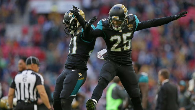 Jacksonville Jaguars defensive back Peyton Thompson (25), right, and Jacksonville Jaguars cornerback Prince Amukamara (21) celebrate after winning an NFL football game against the Indianapolis Colts at Wembley stadium in London, Sunday Oct. 2, 2016. (Associated Press)