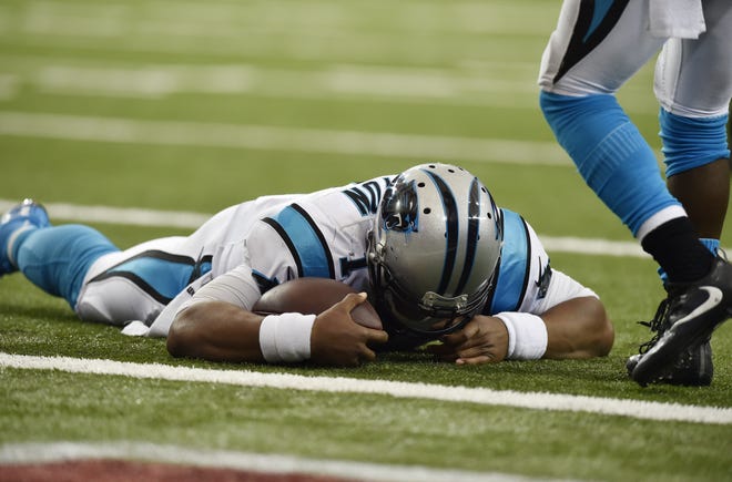 Panthers quarterback Cam Newton lies on the turf after a hit during a two-point conversion against the Falcons during the second half of Sunday's game in Atlanta. Newton left the game with a concussion and did not return. AP Photo/Rainier Ehrhardt