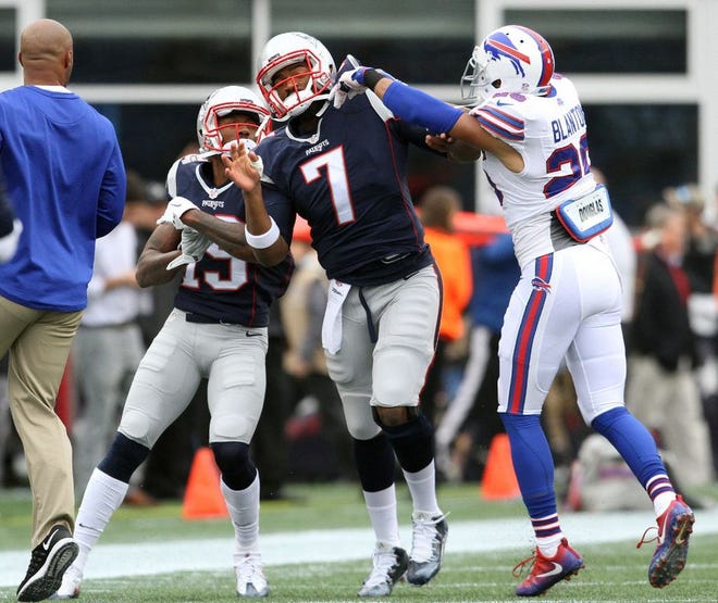 Bills safety Robert Blanton , right, pushes Patriots quarterback Jacoby Brissett (7) during a pregame scuffle on Sunday. Patriots wide receiver Malcolm Mitchell looks on.