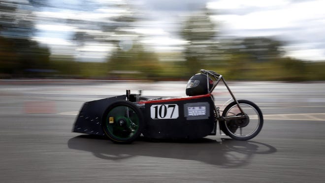 Ryan Schrekengast drives the number 107 electric car around the 21st Kilowatt Klassic course at the Valley River Center parking lot. Students and adults raced on the just more than half-mile course. Willamette High School students have teamed with EWEB to construct and race electric cars. (Andy Nelson/The Register-Guard)