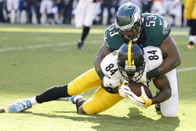 (File) Eagles linebacker Nigel Bradham, shown tackling Pittsburgh Steelers wide receiver Antonio Brown in last Sunday's win, was reportedly charged with a weapons misdemeanor during the team's bye week.