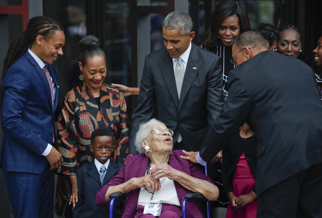 President Barack Obama and first lady Michelle Obama, with members of the Bonner family, including 99-year-old Ruth Odom Bonner, center, at the dedication ceremony for the Smithsonian Museum of African American History and Culture on the National Mall in Washington on Sept. 24. Four generations of the family, descended from Elijah B. Odom, a young slave who escaped to freedom, rang a bell from First Baptist Church, founded in 1776 and one of the country's oldest African-American houses of worship. (AP Photo/Pablo Martinez Monsivais)